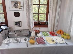 a table with many plates of food on it at комплекс Щастливците in Starozagorski Bani