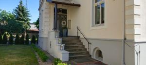 a stairway leading to a door of a house at Apartament WILLA ANTA in Dębno