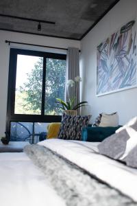 a bedroom with a bed and a large window at 101 Bridgewater Apartment in Cape Town