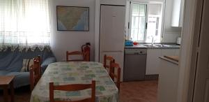 a kitchen with a table and chairs and a kitchen with a sink at Casa El Algarrobico in Agua Amarga