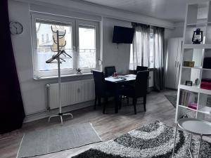 a living room with a table and chairs and a window at Ferienwohnung am MeetingPoint in Weilmünster