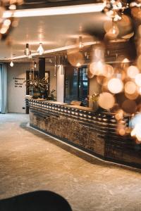 a bar in a restaurant with a brick wall at Hotel Wagnerhof in Pertisau