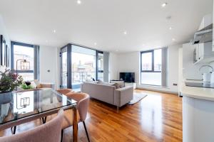 a living room with a couch and a table at Immaculate 3BR apt in Hackney in London