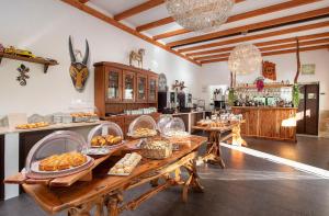 a kitchen with a table with food on it at Hotel Rurale Orti di Nora & SPA in Santa Margherita di Pula
