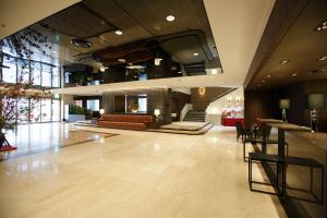 a lobby of a hotel with a couch and a bar at Matsue Excel Hotel Tokyu in Matsue