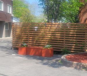 a wooden fence with two potted plants on it at Seasons Inn Halifax in Halifax