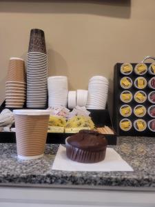 a table with plates and a chocolate cupcake on a counter at Seasons Inn Halifax in Halifax