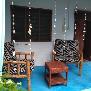 a group of chairs sitting in a room at Furaha B&B Kendwa in Kendwa