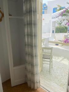 a sliding glass door with a view of a patio at Korali Hotel in Antiparos Town