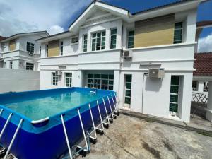 a house with a swimming pool in front of it at Penang Balik Pulau Swimming Pool BBQ Homestay in Balik Pulau