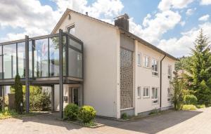 a large white building with large glass windows at Unique: Geräumige 4 Zimmerwohnung in Tuttlingen mit Sauna, Fitness und Netflix OG in Tuttlingen