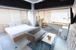 a bedroom with a bed and a chair and a desk at TOKYO-W-INN Asakusa in Tokyo