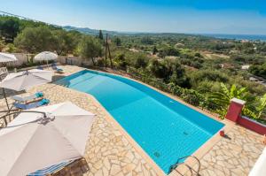 a villa with a swimming pool and views of the ocean at Red Queen in Sfakerá