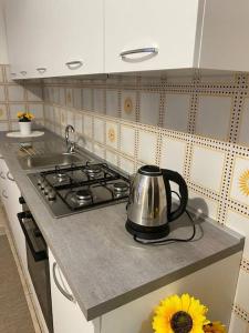 a tea kettle sitting on top of a stove in a kitchen at “Temesa House” il mare a due passi da te! in Campora San Giovanni