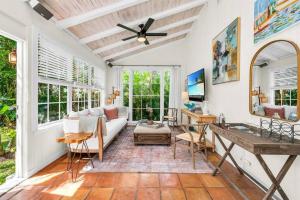 a living room with a couch and a table at Tropical Estate w/ Guesthouse & Pool. Sleeps 8! in West Palm Beach