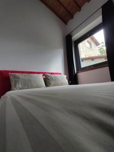 a bedroom with a large bed and a window at Villa Giulia Fashion B&B in Strada