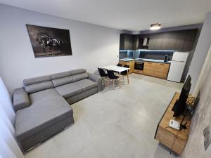 a living room with a couch and a kitchen at Horizont Apartment Sozopol in Sozopol