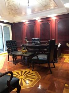 salon ze stołem, krzesłami i fortepianem w obiekcie شقة فخمة علي كورنيش النيل - المعادي w Kairze