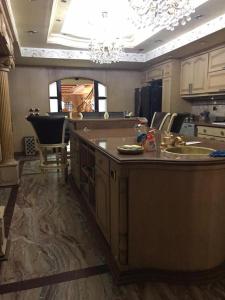 a kitchen with a large island in the middle at شقة فخمة علي كورنيش النيل - المعادي in Cairo