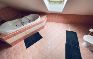 a bathroom with a tub and a toilet at Ubytovanie Žaneta in Krásnohorské Podhradie