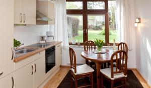 a kitchen with a table and chairs and a window at Idyll am Weinberg in Rhodt unter Rietburg
