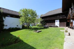 a large yard with a picnic table and a building at Penzion Mauritz in Nová Pec