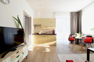 a living room with a kitchen and a dining room at Apartamenty Pod Gwiazdami in Ustroń