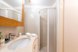 a bathroom with a sink and a shower at Corso Cavour Luxury Apartment in Verona +50 photos
