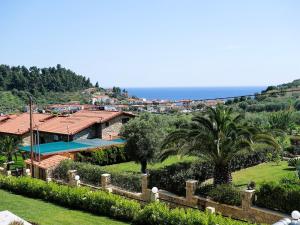 a villa with a swimming pool and the ocean at Blue Dream Villa in Nea Skioni