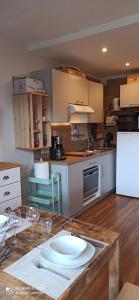 a kitchen with a table with a plate on it at studio Loubat pyrénée, ménage inclus in Arette