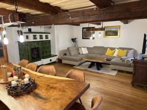 a living room with a couch and a table at Roubenka Kailas in Červená Voda