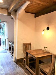 a dining room with a wooden table and chairs at Kyono Mori Yurinsha in Kyoto