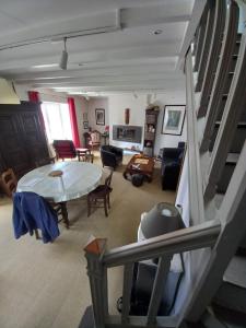 a living room with a table and some chairs at Maison de vacances à la plage in Saint-Nic