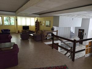 a living room with couches and a couch and a television at Dias Hotel in Kusadası