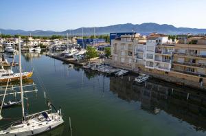 a group of boats docked in a marina with buildings at Pierre & Vacances Empuriabrava Marina in Empuriabrava