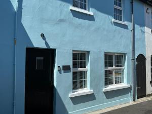 a blue building with a door and two windows at 2 hunters lane Donaghadee in Donaghadee