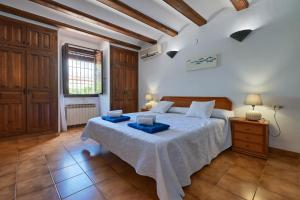 a bedroom with a bed with two blue trays on it at Villa Nathalie in Jávea