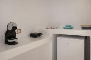 a coffee machine sitting on a white counter top at Feel Breeze in Mikonos +50 photos