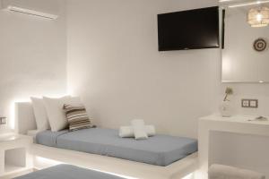 a white room with a bed and a sink at Feel Breeze in Mikonos
