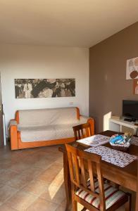 a bedroom with a bed and a table and a dining room at A casa di Miele in Campagnano di Roma