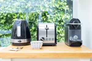 a counter top with a coffee maker and a toaster at Secluded Spacious Garden Suite in Chichester