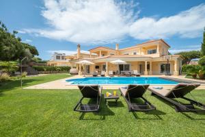 a villa with a swimming pool and lawn at VILLA SIBLING 2 in Vilamoura