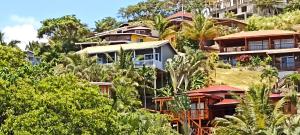 a group of houses on a hill with trees at apartmán Roatan A24 Czech Village in Arrozal