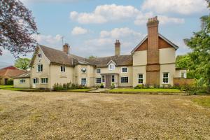 a large white house with two chimneys at Ashfield Place Farm by Group Retreats in Stowmarket