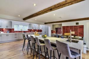 a kitchen with a large dining table and chairs at Ashfield Place Farm by Group Retreats in Stowmarket