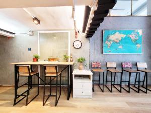 an office with a table and chairs and a map on the wall at Citin Sukhumvit 11 Nana Bangkok by Compass Hospitality in Bangkok