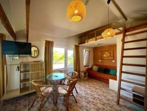 a living room with a table and chairs and a couch at H by Hambar in Vama Veche