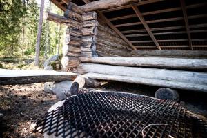 a grill in front of a log cabin at Tahlo Luxury Tent Glamping in Mutala