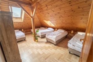 una camera con tre letti in una cabina di legno di BlissHouse Cracow a Cracovia