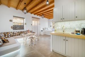 a kitchen and living room with a couch and a table at Petrias Pool House in Serifos Chora